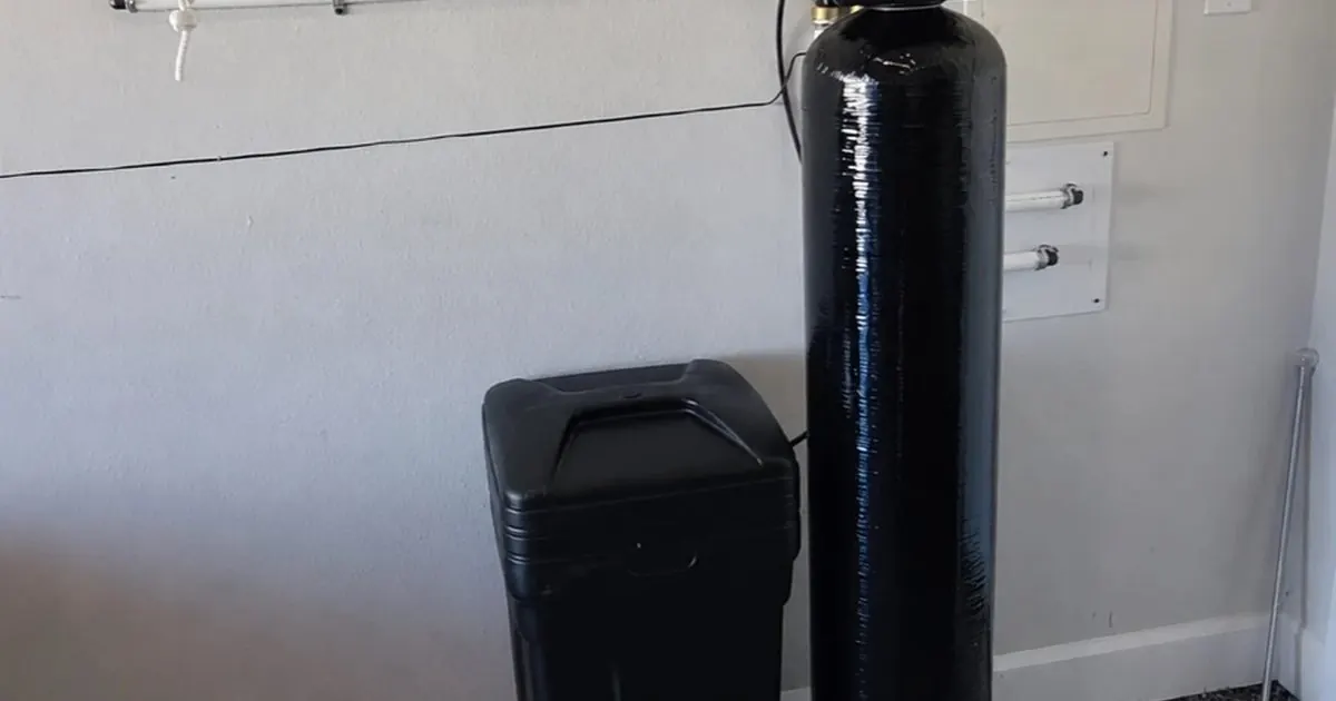 Salt-based water softener with brine tank installed next to a salt-free conditioner tank in a South Florida garage